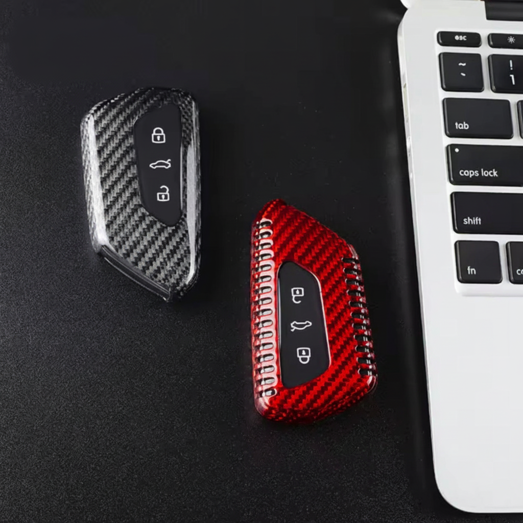 VW key covers on dark surface with laptop
